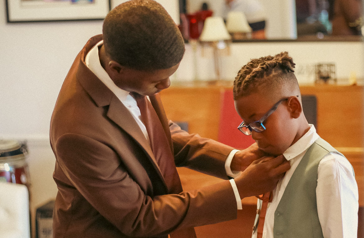 Dontavious adjusting a young attendant’s tie before the wedding.