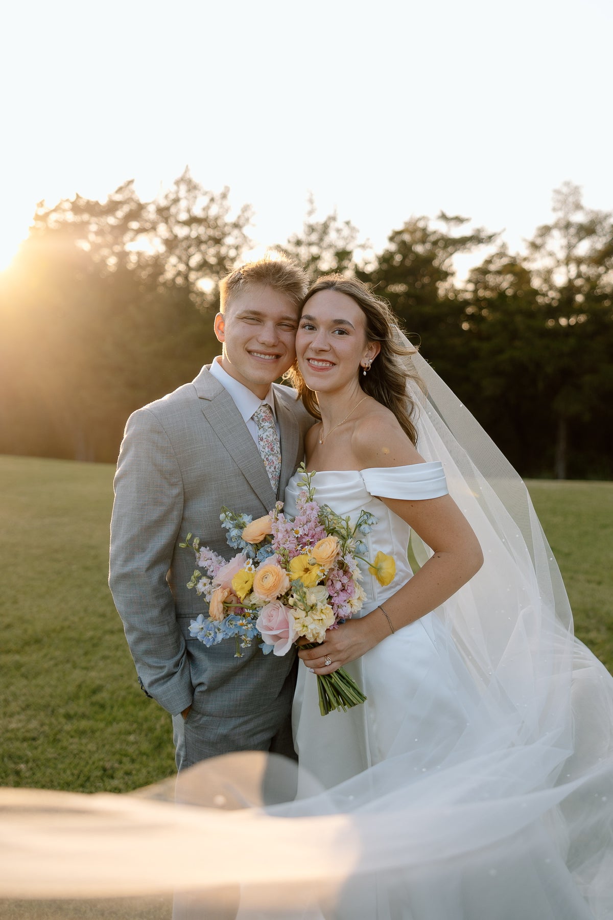 Ava and Ryan together at sunset with her bridal bouquet.