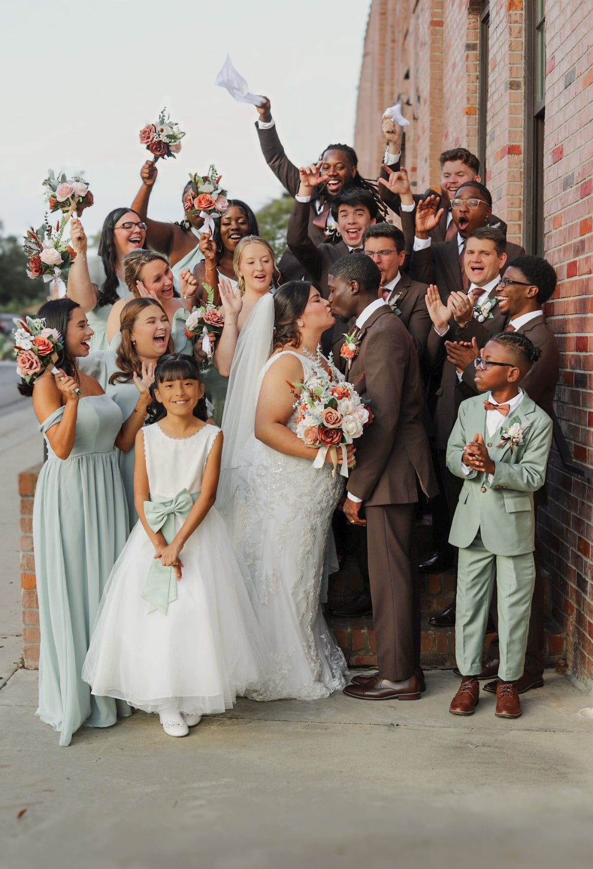 Alejandra and Dontavious celebrating with their wedding party outside the church.