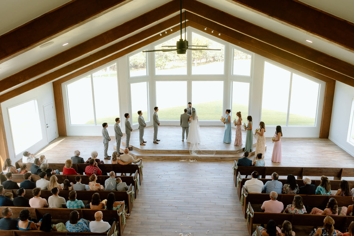 Ava and Ryan during their ceremony in a bright chapel.